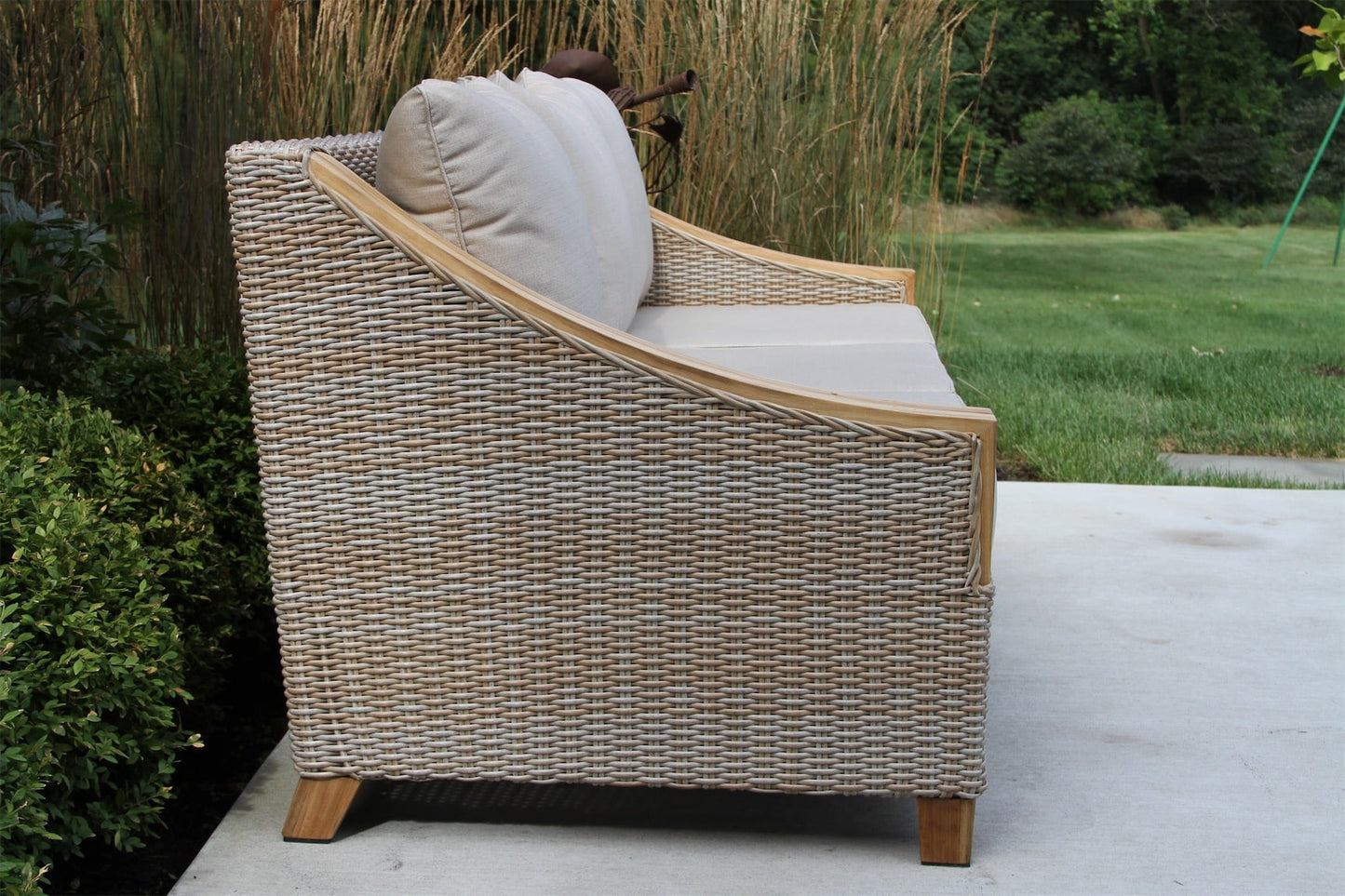 Outdoor Interiors TNA7000 Teak & Wicker Sofa with Sunbrella Cushions & Pillows